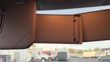 Interior view of a 2019 Nissan Kicks showing the sun visor with a clip and its textured surface