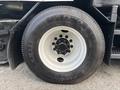 Close-up of a tire on a 2012 International DuraStar 4300 featuring a sturdy rim and visible tread design showcasing the Eurovan AD20 tire model