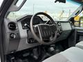 Interior view of a 2016 Ford F-550 Super Duty featuring a steering wheel dashboard and seating with controls and gauges visible