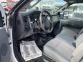 Interior view of a 2015 Ford F-550 showing the steering wheel dashboard and front seats with gray upholstery
