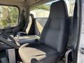 Interior of a 2006 Freightliner M2 106 showing driver and passenger seats with a central console