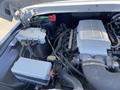Close-up of the engine compartment of a 1962 Ford 2WHDR featuring a large silver engine cover with a horse emblem and various wires and components visible