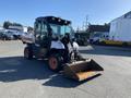 A 2015 Bobcat 5600 compact utility vehicle with a front loader attachment and rubber wheels parked in a lot