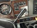Interior view of a 2008 Kenworth T370 with a focus on the gear shift lever labeled NOT FOR PARKING and the dashboard featuring various dials and buttons