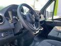 Interior view of a 2022 Mercedes-Benz Sprinter showing the steering wheel dashboard and front seats
