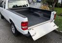 A 2011 Ford Ranger pickup truck with an open tailgate showing the bed liner and interior of the cargo area