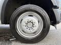 A close-up view of a wheel and tire from a 2008 Ford F-450 showing a silver alloy rim and a black tire with visible tread pattern and specifications