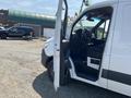 A 2022 Mercedes-Benz Sprinter van with an open door revealing a spacious interior and driver's seat