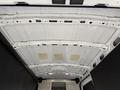 Interior view of a 2022 Ford Transit van showing the white metal ceiling structure with supports and flat sections