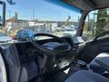Interior view of a 2016 Isuzu NPR-HD showing the steering wheel dashboard and driver's seat