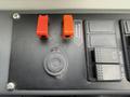 Control panel featuring two red toggle switches labeled interlock override and buttons for retarder and fast idle settings