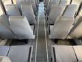 Interior of a 2009 International 3000 CE school bus featuring rows of gray padded seats arranged along the aisle