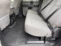 A 2020 Ford F-550 with a spacious interior featuring gray fabric seats and rubber floor mats