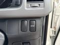 Close-up of the controls inside a 2009 Toyota Hiace showing three buttons including one labeled STEP