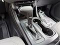 The gear shift lever and center console of a 2017 Chevrolet Colorado with gear selection indicators and cup holders