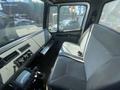 Interior of a 1997 Freightliner FL70 showing a driver’s seat and dashboard controls without a visible driver