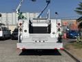 A 2011 Ford F-550 truck with a flatbed and tool storage compartments visible at the rear