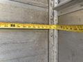 A 2012 Ford Econoline with a measuring tape extended across its interior surface