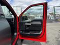 A 2019 Ford F-150 with the driver's side door open showcasing the interior features and door panel design
