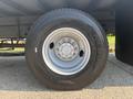 A close-up of a 2012 Hino 338 truck tire showcasing the wheel rim and tread design