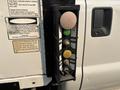 Control panel with buttons for a 2009 Ford F-550 featuring yellow and purple buttons along with black and white switches for operational functions
