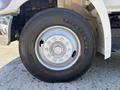 Close-up of a 2020 Hino 338 truck wheel showing the tire and rim design with visible lug nuts and the Firestone logo on the tire sidewall