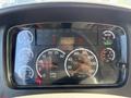 Dashboard of a 2012 Freightliner M2 106 showing speedometer, tachometer, and various warning gauges including oil and water temperature indicators