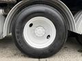 A close-up of a white wheel and tire from a 2013 International Workstar 7500 featuring a Firestone tire with the model number PS591