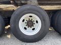 A close-up of a white wheel on a 2011 Autocar Xpeditor showing the tire tread and lug nuts