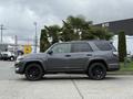 A 2021 Toyota 4Runner in gray with black wheels parked beside palm trees