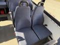 A pair of blue upholstered seats with high backs in a vehicle interior designed for passenger comfort