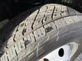 Close-up of a used tire with visible tread pattern and some dirt showing wear on a 2002 Ford Econoline