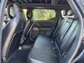 Interior view of the rear seating area of a 2023 Fisker Ocean featuring leather seats and a spacious layout