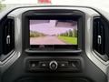 Rearview camera display of a 2022 GMC Sierra 1500 showing a view of the road behind with guidelines for parking assistance