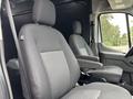 A 2020 Ford Transit 250 with two front seats featuring a gray fabric design and armrests