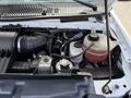 Close-up of the engine compartment of a 2018 Ford E-450 showing various components including the air intake hose coolant reservoir and engine parts