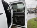 A white 2013 Chevrolet Silverado 3500HD with an open front door revealing the interior and armrest of the driver side