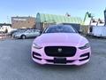 A pink 2020 Jaguar XE facing forward with a sleek design and distinctive grille