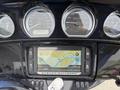 A 2017 Harley-Davidson FLHTKL dashboard featuring speedometer tachometer and a navigation screen displaying a map