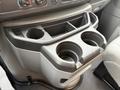 A cup holder console with two circular cup holders and a storage compartment designed for a 2024 Ford E-450