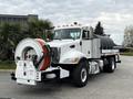 A 2016 Peterbilt 348 truck with a large tank and a hose reel mounted on the front for water or liquid management
