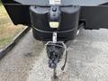 A 2021 Jayco Jay Flight travel trailer with a black hitch and safety chain attached to the front coupler