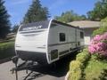 A 2022 Keystone Hide Out RDWE 20RDWE travel trailer with a sleek white exterior featuring the "HIDEOUT" logo in bold black letters