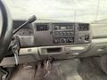 Interior view of a 2004 Ford F-350 SD dashboard featuring a radio climate controls and gearshift with keys hanging from the ignition