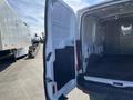 A 2017 Ford Transit van with its back doors open revealing an empty cargo space