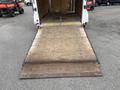 A 2016 Continental cargo trailer with a wooden ramp lowered to the ground inside the trailer's cargo area