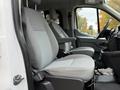 The interior of a 2018 Ford Transit showing two gray automotive seats with a simple design and headrests