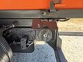A close-up of a 2016 Isuzu NPR-HD vehicle's hitch assembly featuring a lock mechanism and mounting bracket