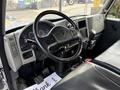 Interior view of a 2012 International DuraStar 4300 featuring a steering wheel dashboard gauges and a gear shift mounted on the floor