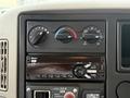 Dashboard controls of a 2014 International TerraStar showing climate control knobs and a Bluetooth-enabled audio system
